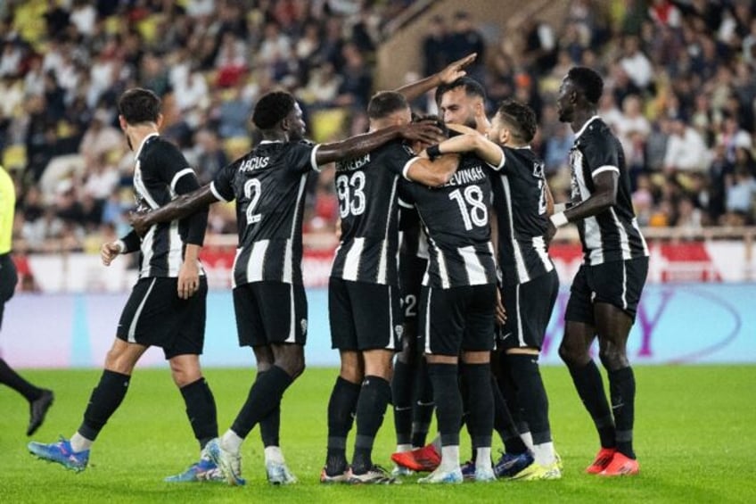 On target: Angers Jean-Eudes Aholou (3R) celebrates with teammates after scoring against M