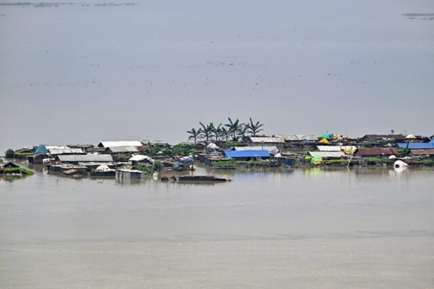 Heavy rains and overflowing rivers have swamped parts of India's northeastern state of Ass