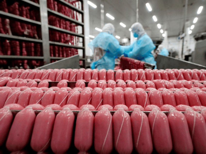 Employees work in a sausage factory in Yutian County, Tangshan City, north China's Hebei P