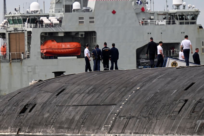 Russian Marines standing on top of the Russian nuclear-powered submarine Kazan (R), part of the Russian naval detachment visiting Cuba, watch Canada's HMCS Margaret Brooke, the second Harry DeWolf-class offshore patrol vessel for the Royal Canadian Navy (RCN), upon arrival in Havana Harbor on June 14, 2024. . The visit of the Canadian warship is to celebrate 80 years of relations between Cuba and Canada and coincides with the presence of a Russian naval force docked in the same port. (Photo by YAMIL LAGE / AFP) (Photo by YAMIL LAGE/AFP via Getty Images)