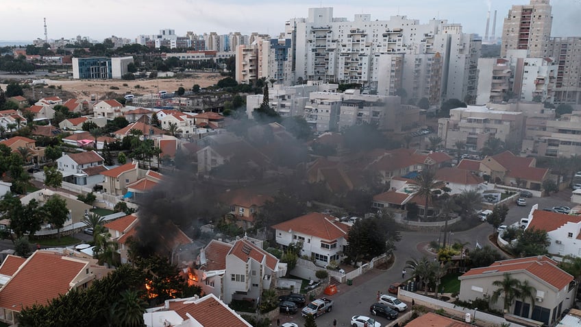Smoke rises after a rocket fired from the Gaza Strip hit a house in southern Israel