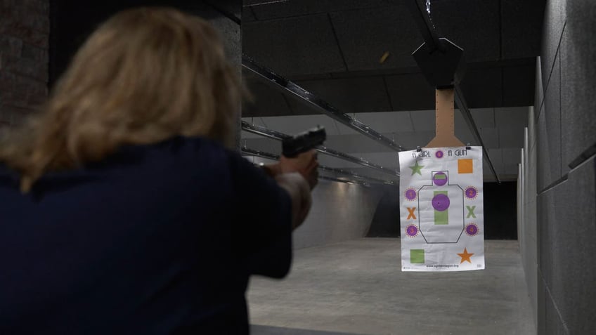 Woman aiming gun