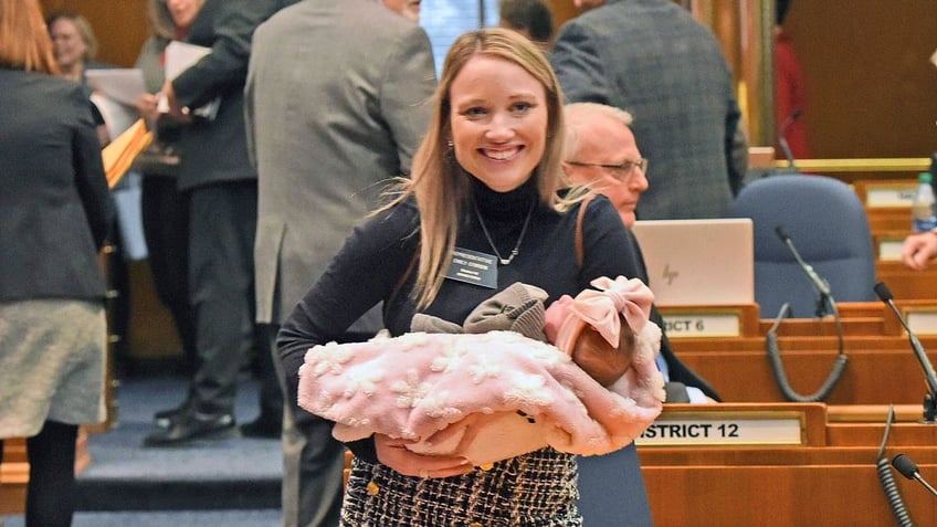 Rep. Emily O'Brien R-Grand Forks carries daughter Jolene Green