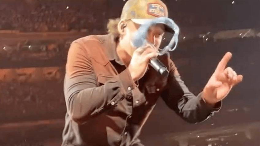 Morgan Wallen performing gets hit with blue underwear on stage