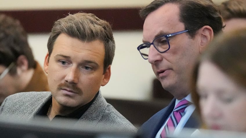 Morgan Wallen talks to his attorney in court