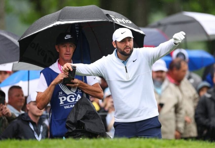 Top-ranked Scottie Scheffler prepares to play a shot on his opening hole, the par-5 10th,