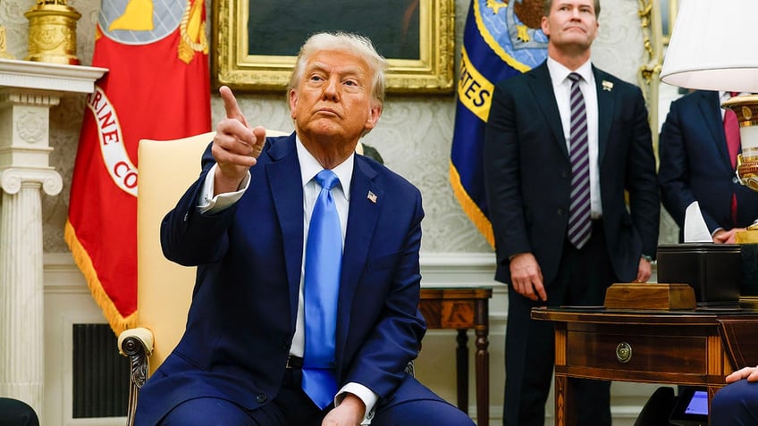 President Donald Trump, accompanied by U.S. National Security Adviser Michael Waltz (R) takes a question from a reporter during a meeting with Israeli Prime Minister Benjamin Netanyahu in the Oval Office of the White House on February 4, 2025, in Washington, DC.