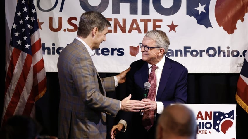 Ohio Gov. Mike DeWine, right, greets Ohio state senator and Republican candidate for U.S. Senate Matt Dolan during a campaign event in Columbus, Ohio, Monday, March 18, 2024. (AP Photo/Paul Vernon)