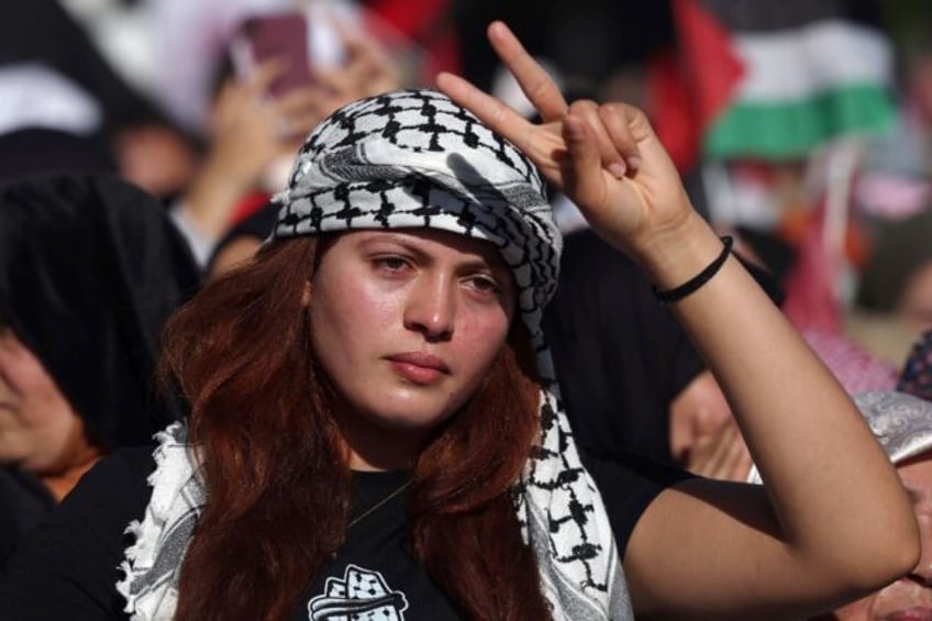 A woman flashes the V for victory sign during the protest in Rabat