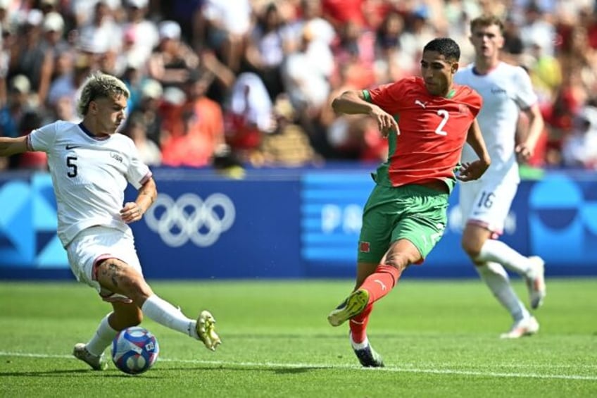 Morocco captain Achraf Hakimi fires in his side's third goal in their comfortable win over