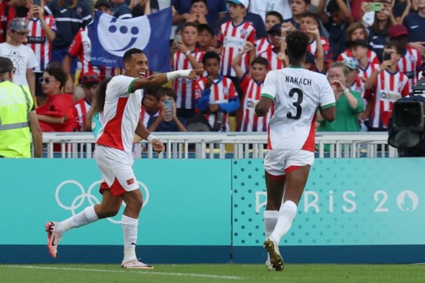 Soufiane Rahimi (L) celebrates scoring Morocco's fourth goal as they hammered Egypt 6-0 on