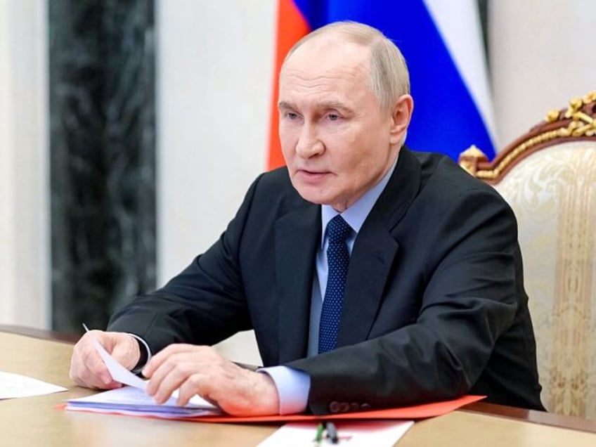 In this pool photograph distributed by the Russian state agency Sputnik, Russia's Pre