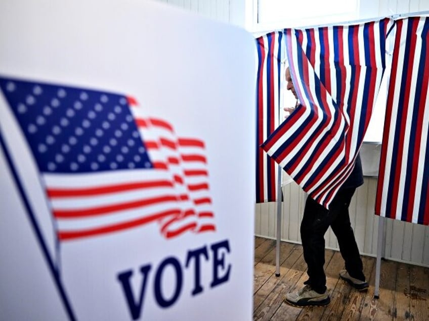 SANBORNTON, NH - JANUARY 23: A voter prepares to leave a voting booth as they take part in