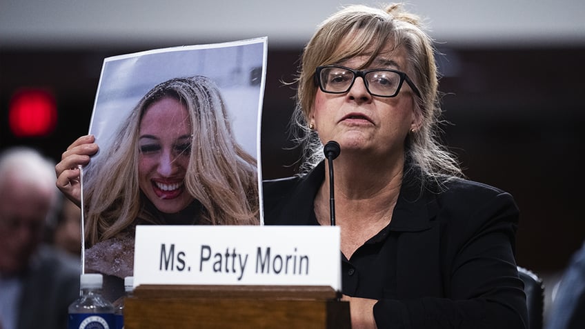 Patty Morin holds a photo of her daughter Rachel Morin, who was murdered by an undocumented migrant in Maryland.