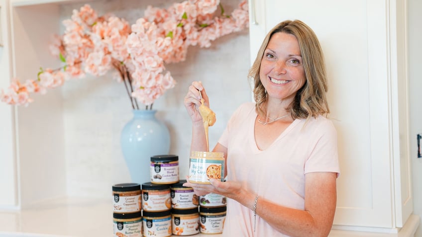 Lea Hurley, founder and CEO of American Dream Nut Butter, holds a spoonful of one of her nut butters.