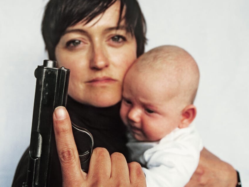 woman with baby and gun