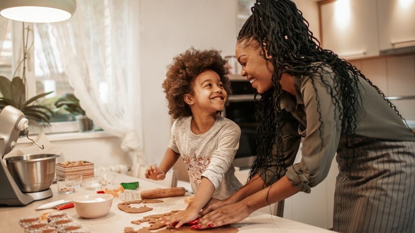 mother and daughter making cookies