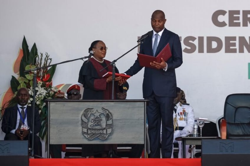 Daniel Chapo (R) was sworn in as Mozambique's president after a disputed election sparked