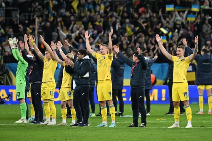 Ukraine players celebrate after qualifying for Euro 2024 by beating Iceland