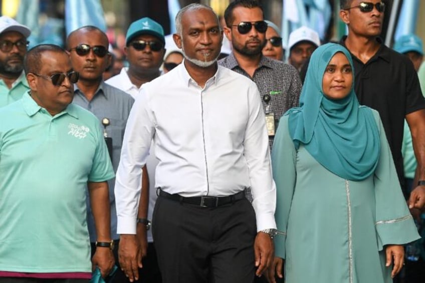 A landslide election victory for his party will Maldives' President Mohamed Muizzu (C) del