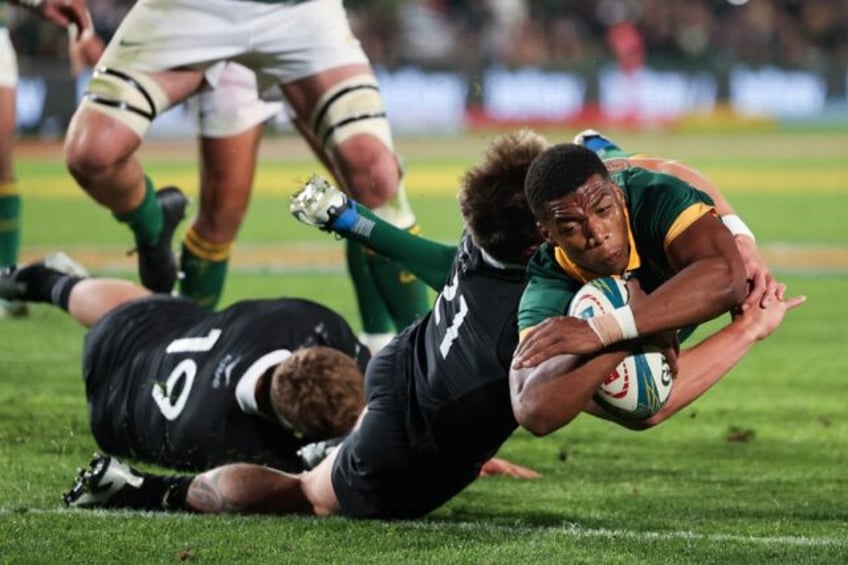 South Africa's scrum-half Grant Williams (R) dives for a try during the Rugby Championship