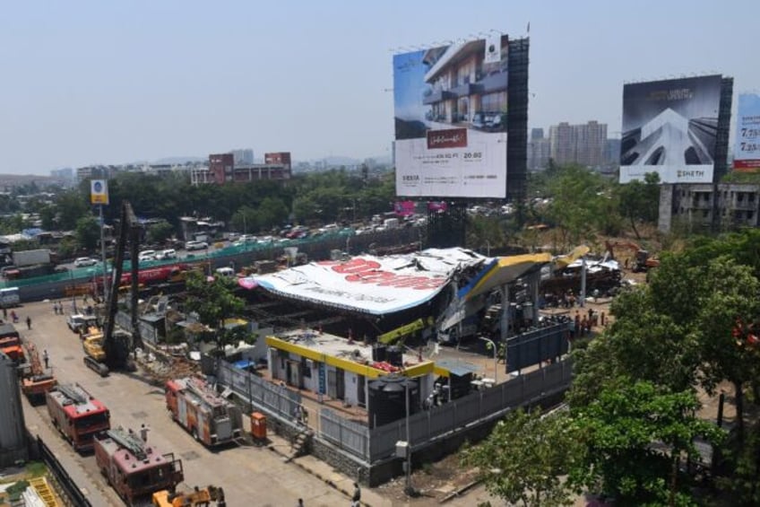 Rescue operations underway after a huge billboard collapsed on a petrol station following