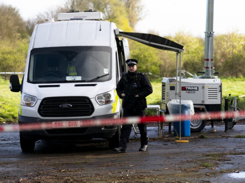 Police near the scene in Rowdown Fields, a park in Croydon, south London where human remai