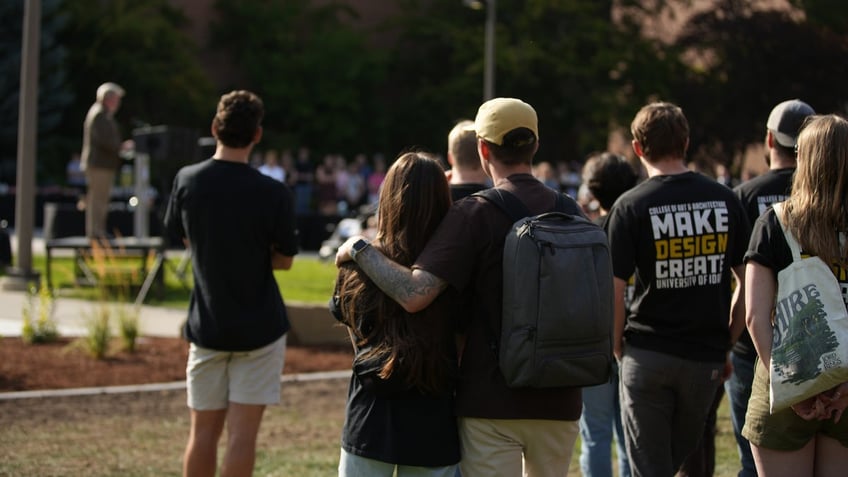 Students embrace as the memorial is presented