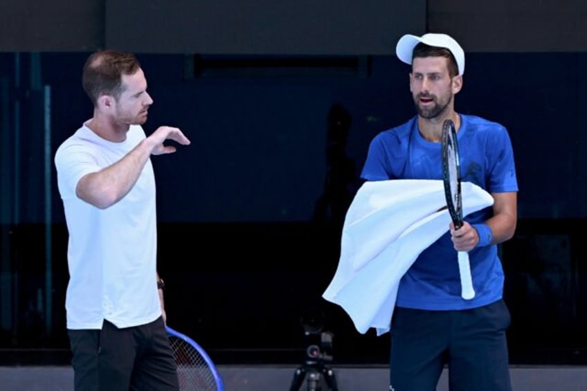 Serbia's Novak Djokovic (R) listens to coach Andy Murray during a training session ahead o