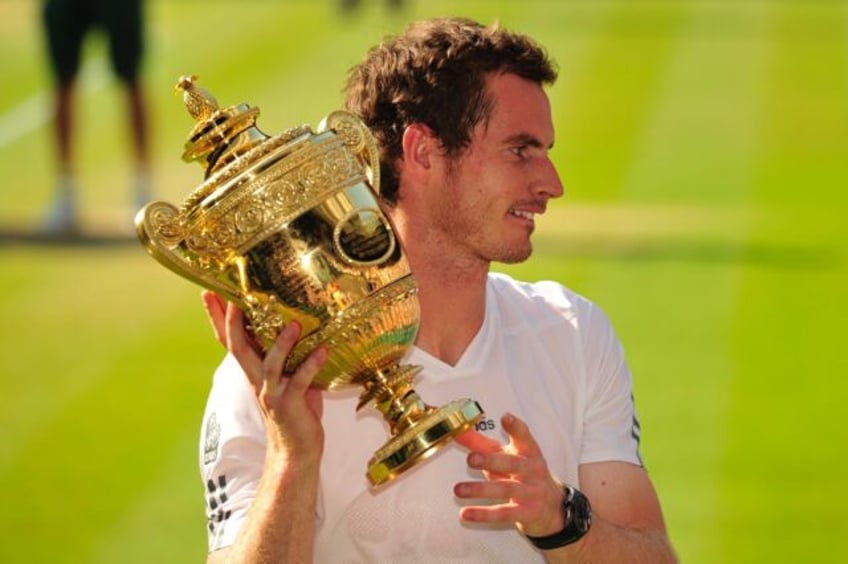 Champion: Andy Murray holds the winner's trophy after beating Novak Djokovic in the 2013 W