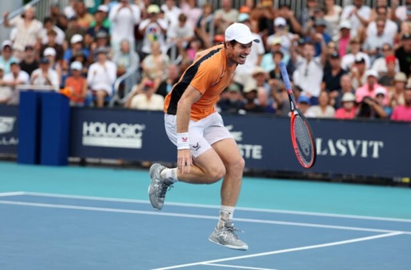 Andy Murray of Great Britain screams in pain after hurting his left ankle during his match