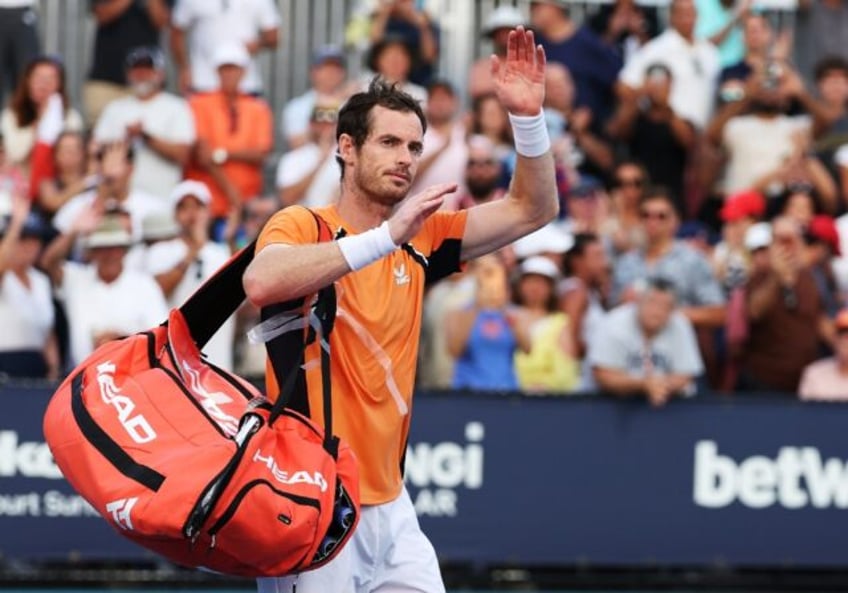 Andy Murray of Great Britain waves to the crowd after losing in three sets against Tomas M