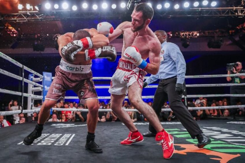 IBF super welterweight world champion Bakhram Murtazaliev knocks down Tim Tszyu on the way