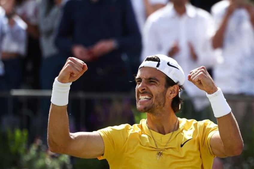 Italy's Lorenzo Musetti celebrates after beating Australia's Jordan Thompson at Queen's Cl