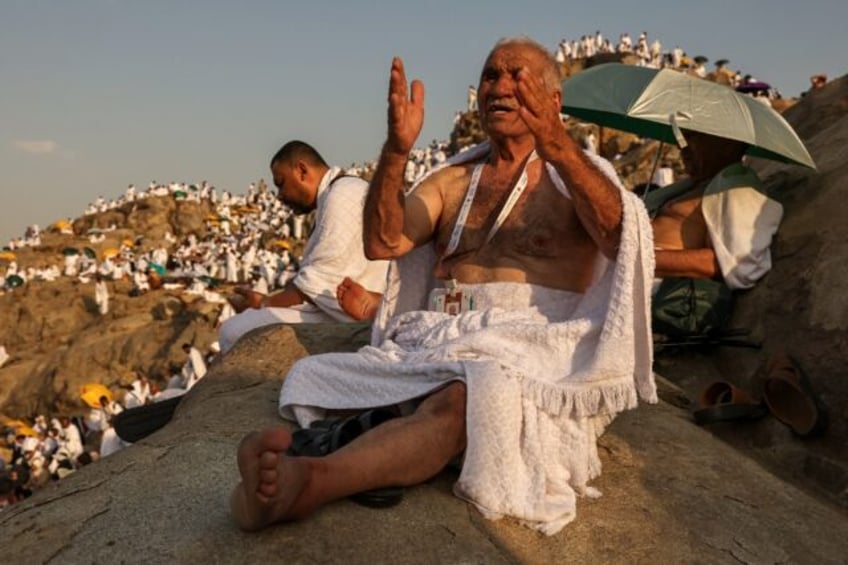 Muslim pilgrims pray at dawn on Saudi Arabia's Mount Arafat