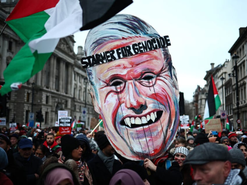 Pro-Palestinian activists and supporters carry a giant mask of Britain's main opposition Labour Party leader, Keir Starmer during a National March for Palestine in central London on January 13, 2024. Hamas's unprecedented attack on Israel on October 7, 2023 which left about 1,140 dead in Israel, mostly civilians, according to …