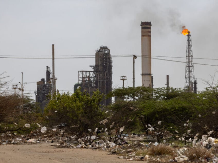 Trash in front of the Petroleos de Venezuela SA (PDVSA) Amuay oil refinery at the Paraguana Refinery Complex in Punto Fijo, Falcon State, Venezuela, on Saturday, Aug. 19, 2023. An ad-hoc board for Venezuela's oil company said it will extend a legal deadline on PDVSA's bonds, echoing an agreement for sovereign debt earlier this week. Photographer: Betty Laura Zapata/Bloomberg via Getty Images