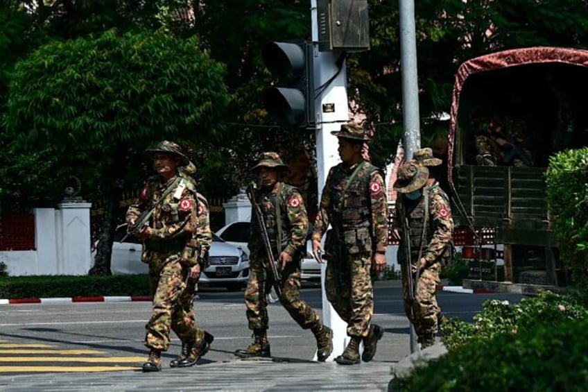 Members of the Myanmar's military security force patrol a street during a 'silent strike'