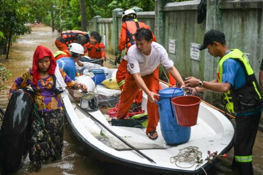 Rescue workers race to evacuate residents affected by severe flooding in Myanmar