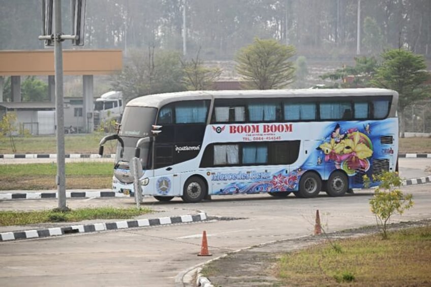 A bus carrying alleged scam centre workers and victims from China handed over from Myanmar
