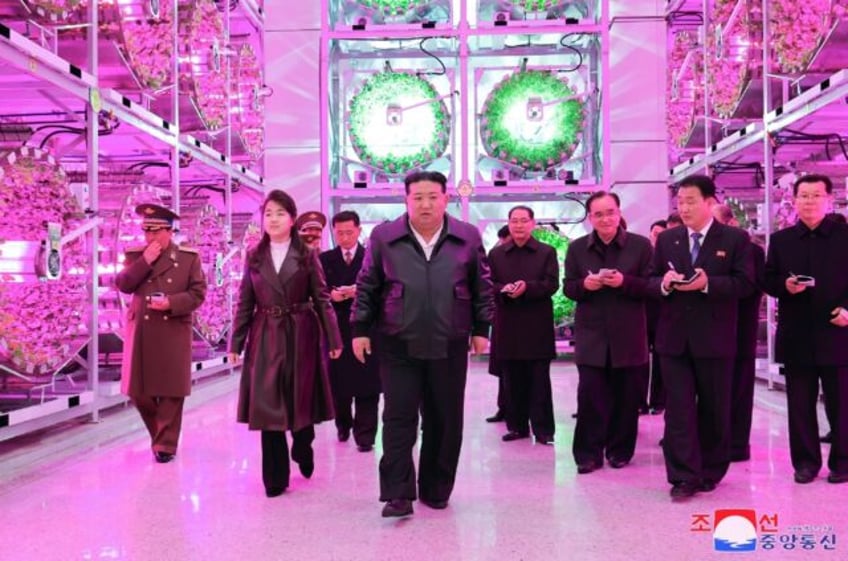 A photo released by North Korean state media shows leader Kim Jong Un (C) and his daughter