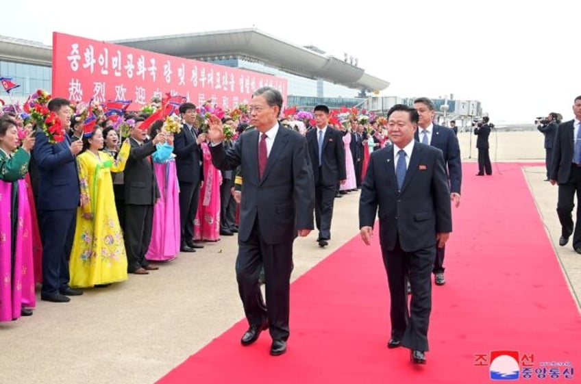 China's top lawmaker Zhao Leji (centre L) walks with Choe Ryong Hae (R), chairman of North
