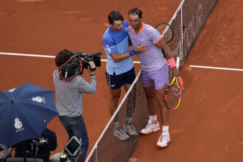 All over: Rafael Nadal with Alex De Minaur after his defeat
