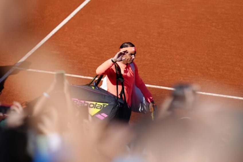 Rafael Nadal waves to fans before facing Flavio Cobolli at the Barcelona Open in his retur