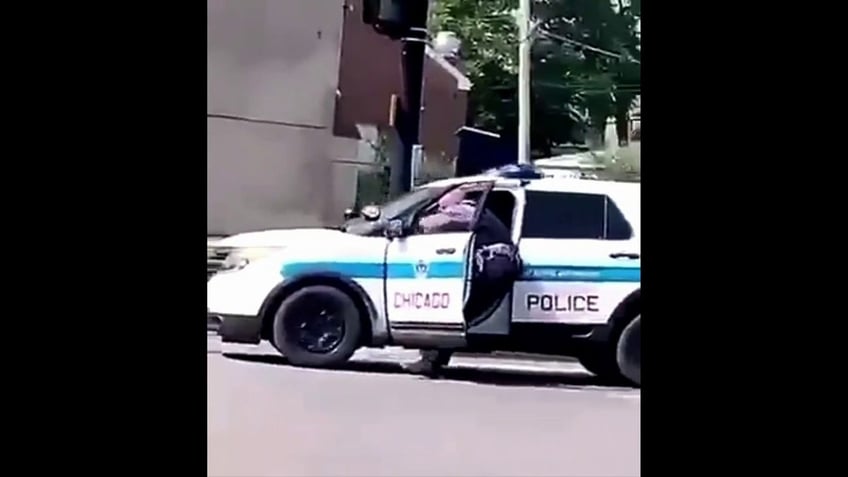 Video screenshot shows moment Chicago cop is forced out of his vehcile.