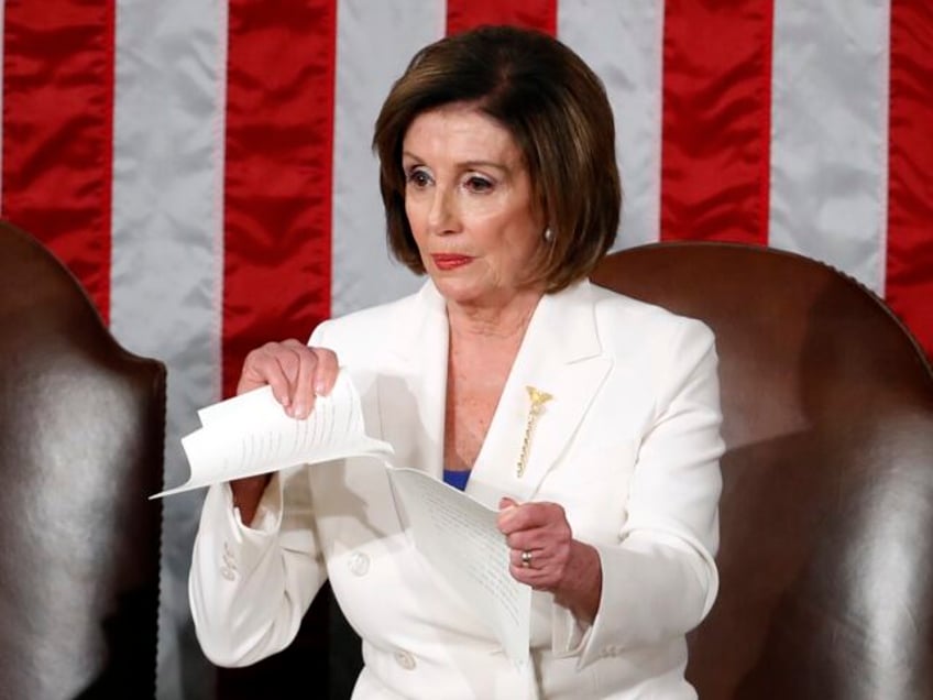 FILE - House Speaker Nancy Pelosi of Calif., tears her copy of President Donald Trump&#039