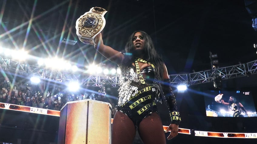 Naomi holds the belt