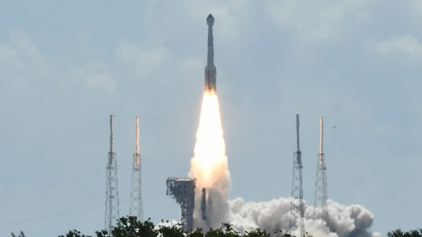 Fire shoots from a rocket as it blasts off from Cape Canaveral Space Force Station for NASA's Boeing Crew Flight Test in Cape Canaveral, Florida.