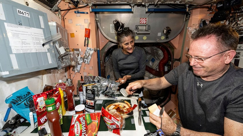 Wimore and Williams eating at the ISS