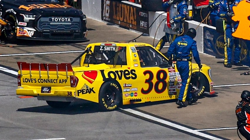 nascar crew member hit in the pits as driver spins out